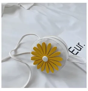 Cute white round toddler crossbody bag detail with big yellow daisy flower decoration.