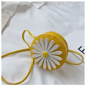 Kids yellow round PU leather crossbody bag with cute white 3D daisy flower design.