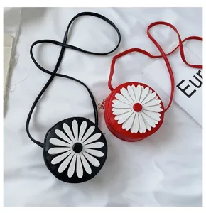Cute round crossbody bag detail featuring white daisy flower motif on black and red PU leather.