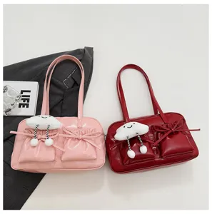 Detailed view of the stylish underarm bowling bag featuring cute plush cloud charm and bow.