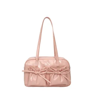 Pink bowling shoulder bag for women, cute bow front pocket design, large capacity handbag.