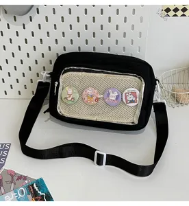 Detailed view of black canvas ita bag with clear window, cute rabbit pin badges, crossbody.