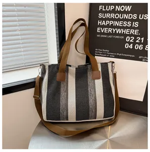 Striped canvas tote bag with brown straps, casual crossbody shoulder bag for daily commute.
