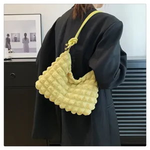 Yellow crinkled shoulder bag for women, stylish underarm hobo bag with knotted strap detail.