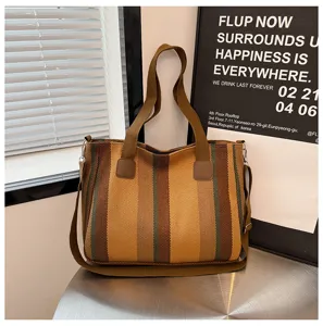 Stylish striped canvas tote bag for women, commuter handbag with adjustable shoulder strap.