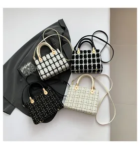 Vue de détail de sacs à main tendance en tweed à carreaux avec ferrures métalliques élégantes.