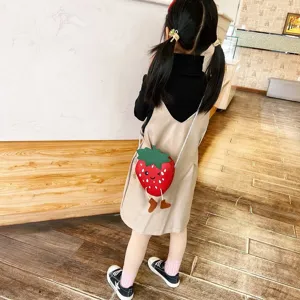 Cute strawberry crossbody bag detail shot, lovely mini children shoulder bag with funny legs.