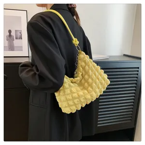 Detail view of the stylish yellow crinkled cloud shoulder bag showing unique pleated texture.