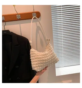 White gathered cloud shoulder bag, detailed view of textured bubble fabric and strap.