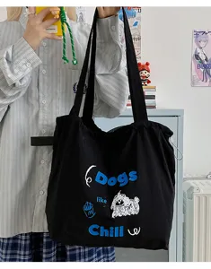 Black canvas tote bag detail, featuring cute dog graphic and stylish English text print.