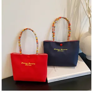 Sac cabas décontracté en toile avec poignées rayées colorées et broderie élégante pour femmes.