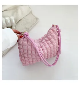 Close up of the pink textured cloud shoulder bag detail, showcasing soft gathered fabric.