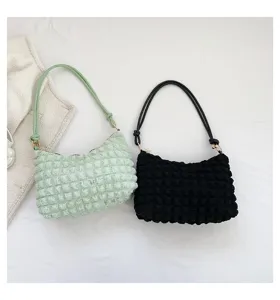 Detailed view of the stylish pleated underarm shoulder handbag in mint green and black colors.