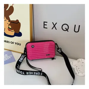 Pink mini suitcase crossbody bag for women, stylish hard shell shoulder travel bag.