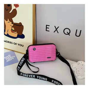 Pink mini suitcase crossbody bag for women, cute hardshell shoulder bag with strap.