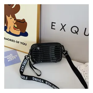 Mini black suitcase crossbody bag with letter strap stylish small square shoulder bag detail view.
