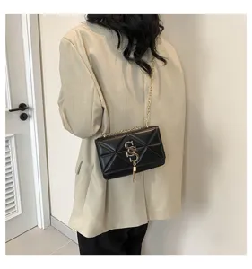 Black quilted chain shoulder bag for women, stylish crossbody bag with metal lock and tassel pendant.