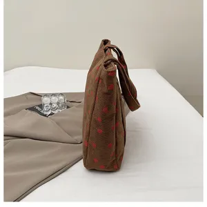 Corduroy strawberry print tote bag detail view, casual shoulder bag for daily use style.