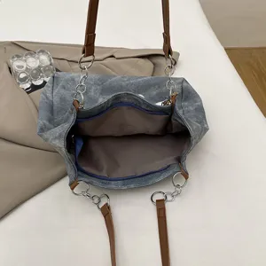 Casual large capacity denim tote bag for women, stylish chain and shoulder strap design main view.