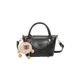 Black mini leather top handle bag cross body shoulder bag with cute plush pendant