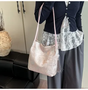 Chic pink shoulder bag detail, exquisite Chinese landscape embroidery with lovely tassel.