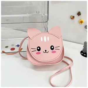 Close-up detail of the cute pink cat-shaped kids crossbody bag with lovely facial features.