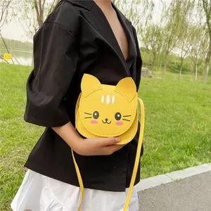Detail view of the cute yellow cat crossbody bag outdoors, perfect for kids fashion daily use.