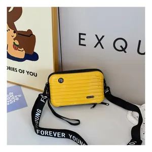 Yellow mini suitcase cross-body bag featuring hard shell groove design and stylish letter strap.