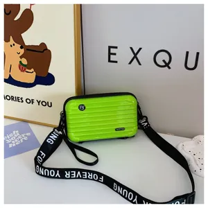 Mini green suitcase crossbody bag for women, stylish hard shell travel box shoulder bag.