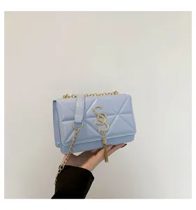 Light blue chic chain shoulder bag for women, trendy quilted crossbody bag with tassel.