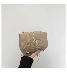 Chic beige quilted shoulder bag detail, elegant gold chain strap and metal clasp design.