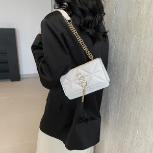 Women white quilted shoulder bag with gold chain and metal tassel lock, stylish crossbody.