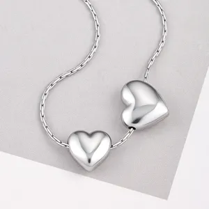 Close-up detail of stainless steel polished double heart charm bead pendant accessory