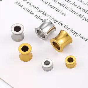 Close-up detail of stainless steel gold and silver trumpet spacer beads for DIY jewelry making.
