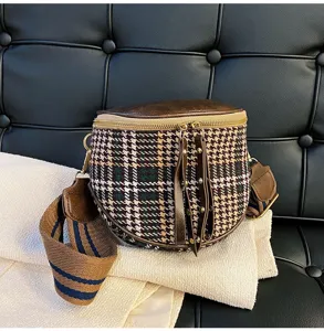 Detailed view of women's autumn winter vintage plaid crossbody bag with wide strap.