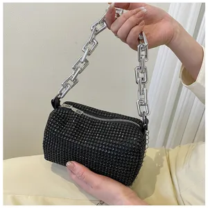 Detailed view of a trendy black rhinestone cylindrical shoulder bag with chunky chain strap.