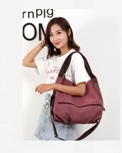 Detail view of women casual canvas shoulder bag in wine red with durable dual straps style.