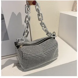 Detailed view of the sparkling rhinestone cylinder shoulder bag with chunky silver chain strap.