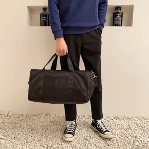 Black travel duffel bag large capacity waterproof fitness gym bag for men and women short trips.