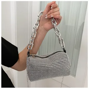 Rhinestone cylindrical shoulder bag featuring a chunky silver chain strap and sparkling detail.