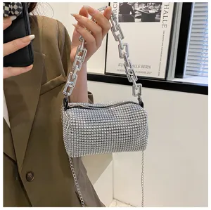 Rhinestone crystal cylinder handbag detail, stylish thick chain handle and strap design.