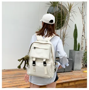 Japanese style campus large capacity canvas backpack with multiple pockets and cool doll pendant.