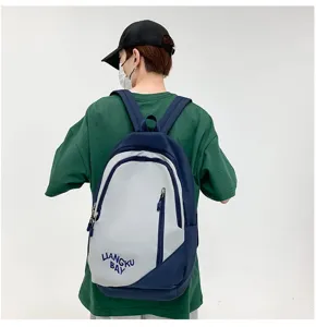 Close-up detail shot of the stylish nylon contrast color backpack showing embroidery.