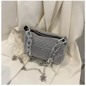 Close-up detail of luxury rhinestone underarm bag featuring sparkling crystals and a chunky chain.