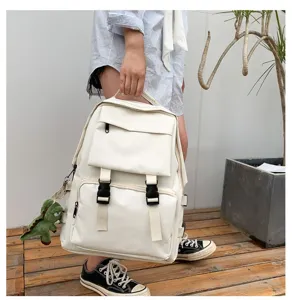 Large capacity canvas school backpack with multiple utility pockets and tactical buckles for daily use.