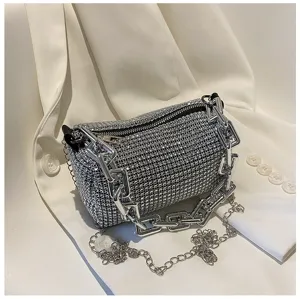 Sparkling rhinestone cylindrical handbag detail, chic silver chunky chain and zipper design.