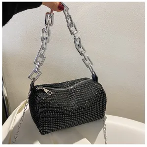 Detailed shot of a black rhinestone cylinder handbag featuring a chunky silver chain strap for women.