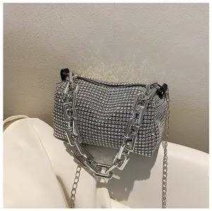 Close up view of luxury rhinestone cylinder shoulder bag with chunky silver chain link.