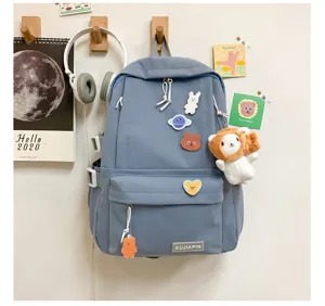 Mochila escolar coreana azul con pines bonitos y un bolsillo delantero práctico.