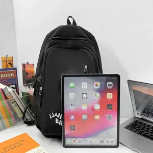 Casual black nylon backpack with multi-pocket design, large capacity for daily school and travel use.